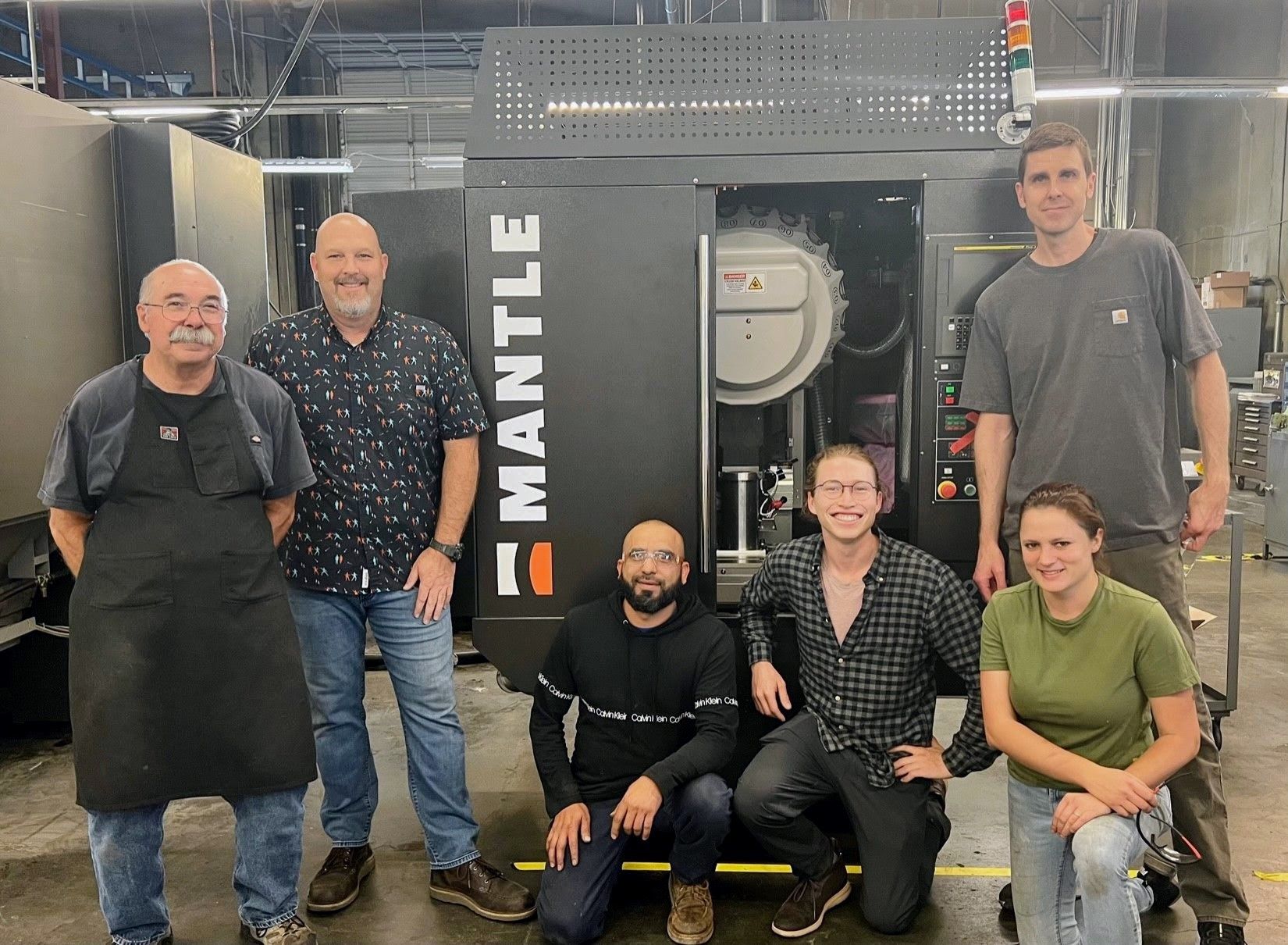 The Westec Plastics team standing next to their new 3D printer