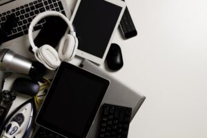 Old computers, digital tablets, mobile phones, many used electronic gadgets devices, broken household and appliances on white background. Planned obsolescence, electronic waste for recycling concept injection molded electronics