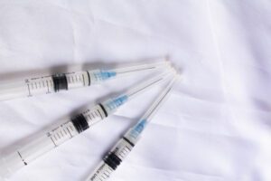 Medical injection syringe with clear measurements and sharp needle tip. Healthcare equipment concept medical plastic injection molding companies